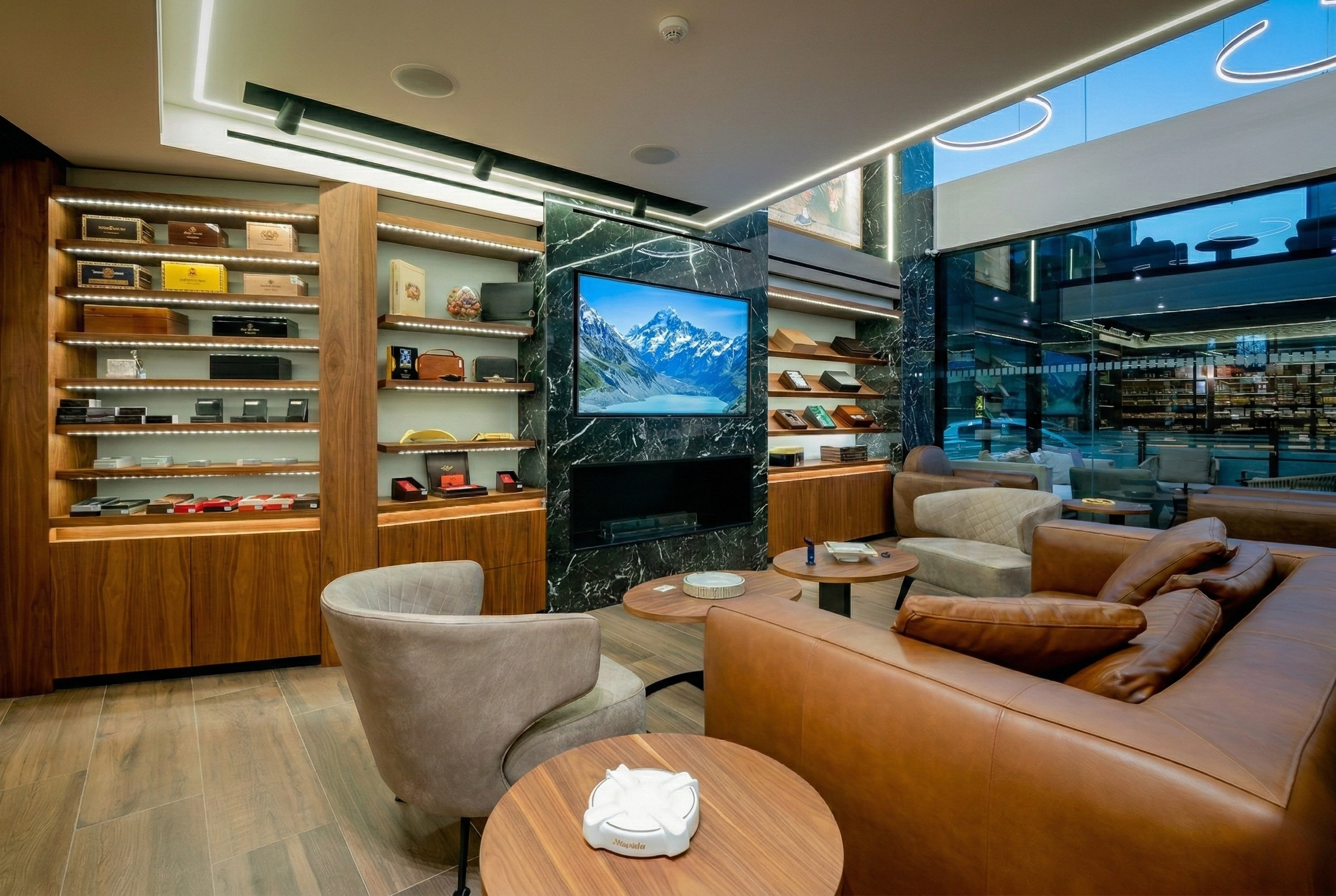 Boutique lounge — leather seating, marble fireplace, walnut shelving
